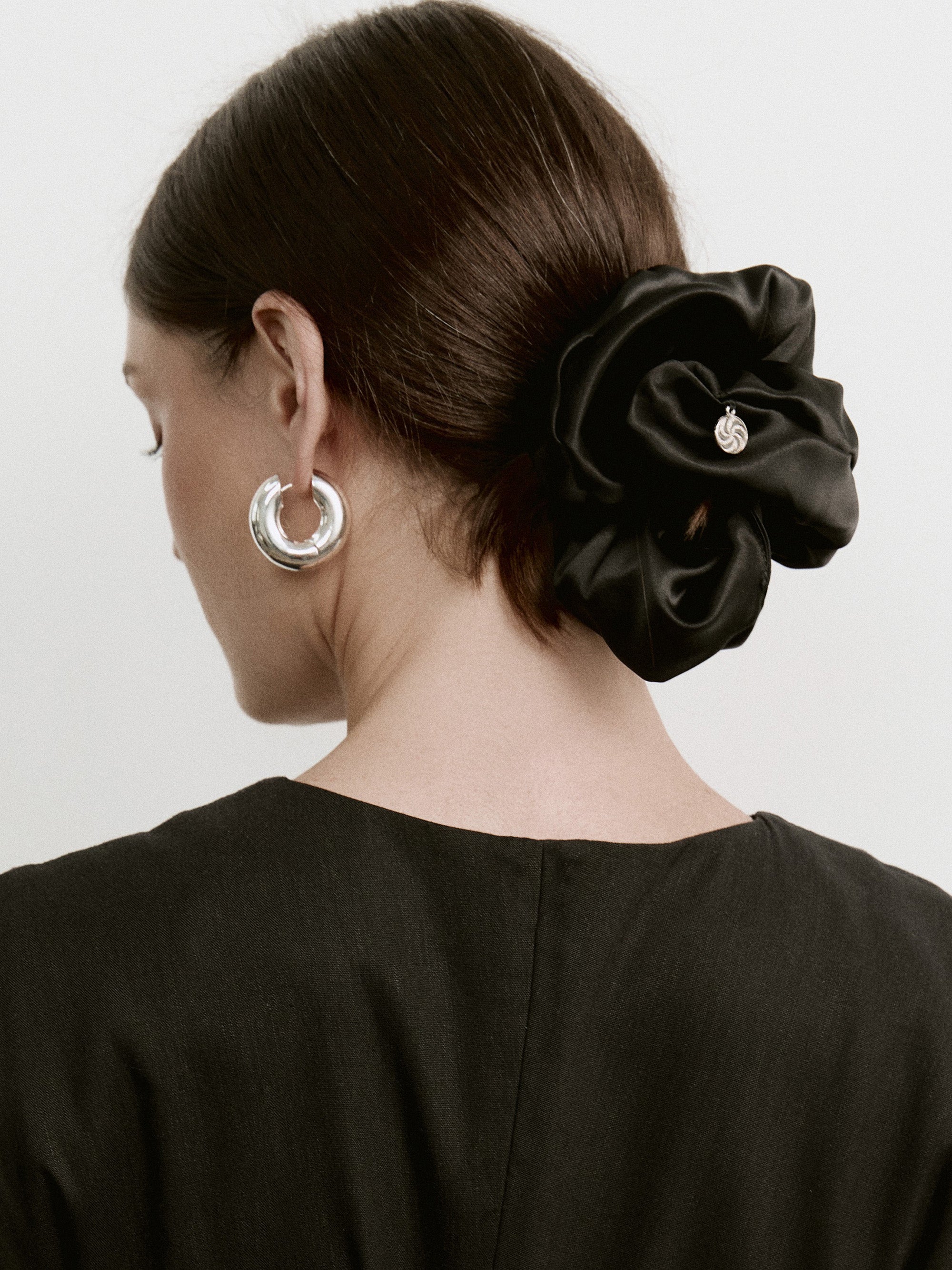 Oversized silk scrunchie in Black - on-model, back view. zoom in - CONTOUROSE