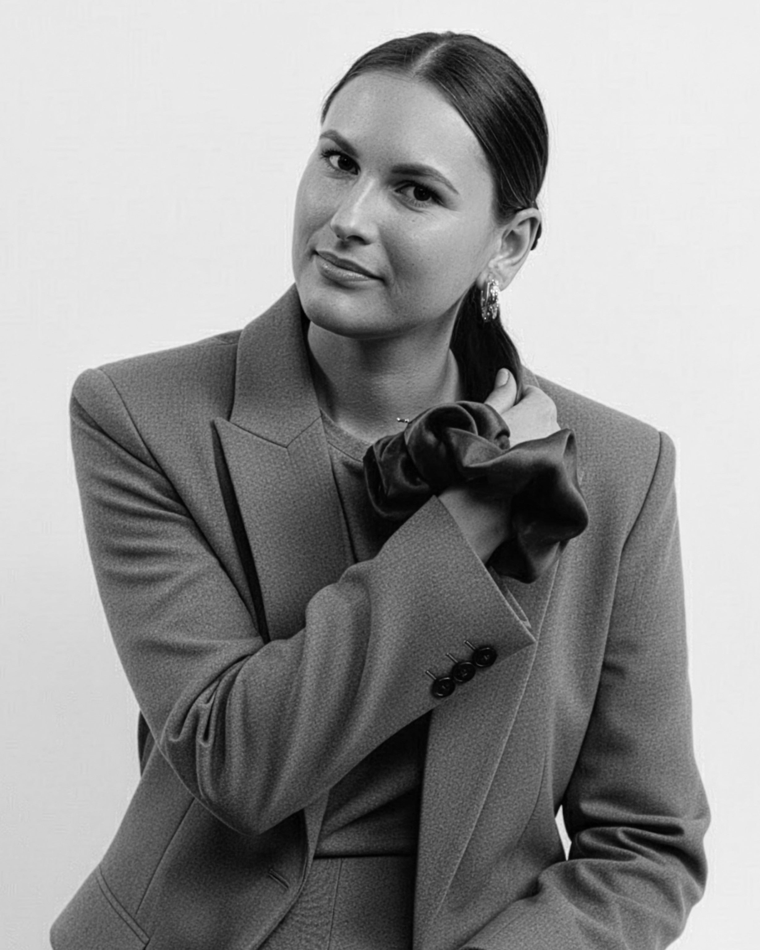 Founder portrait with red scrunchie on wrist - CONTOUROSE