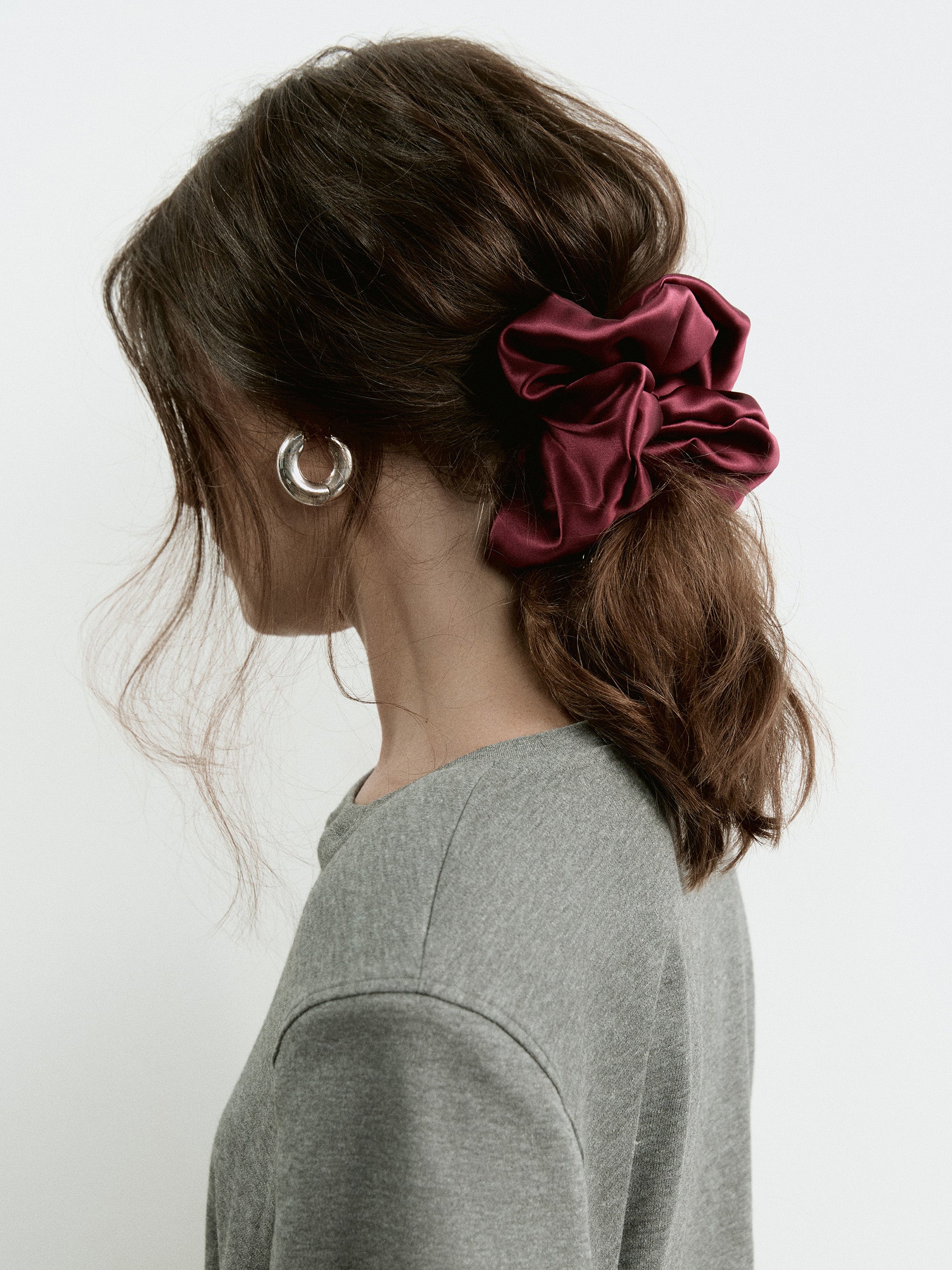 Model wearing an oversized silk scrunchie by Contourose